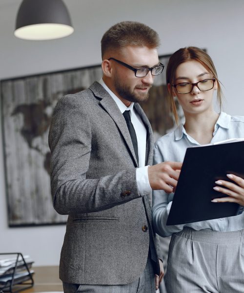 Woman with glasses.Businessman with documents.Colleagues work together